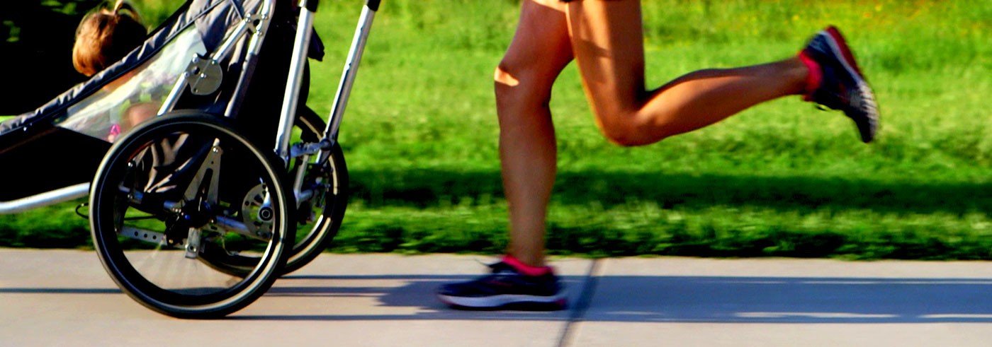 Woman running with her Jogalong Jogging Stroller